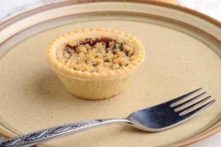 closeup fruit crumble tart with a forkの写真素材