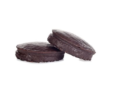 two small chocolate covered sponge cakesの写真素材