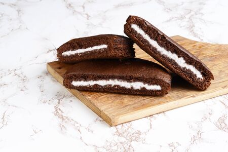 three slices of chocolate cream cake on cutting boardの写真素材