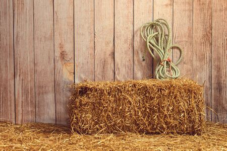 indoor barn with hay bale and rope with nobodyの写真素材