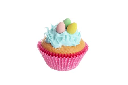 isolated easter cupcake with blue frosting and chocolate mini eggsの写真素材