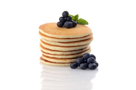 pile of fresh pancakes with blueberries and mint on a white backgroundの写真素材