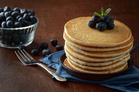 blueberry pancakes with a fork on a blue napkinの写真素材