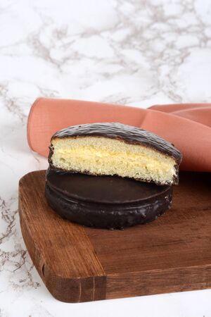 custard filled chocolate sponge cake with a napkinの写真素材