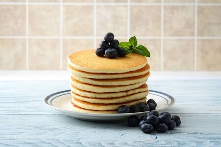 stack of pancakes with pile of blueberries on plateの写真素材