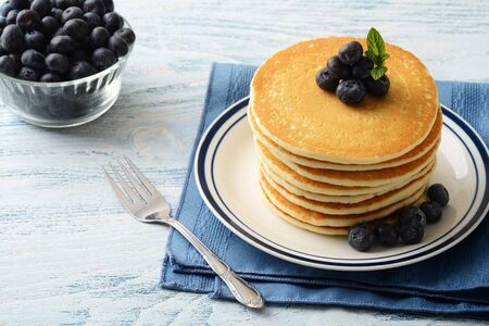 blueberry pancakes on a plate with a forkの写真素材