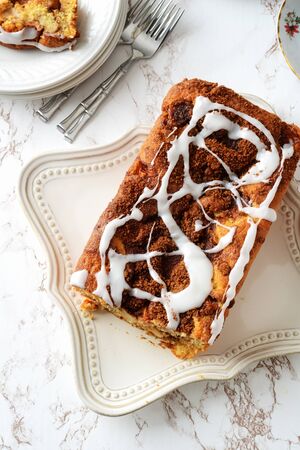 high angle apple fritter loaf bread cake with icing sugarの写真素材