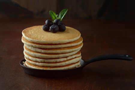 blueberry pancakes with mint in cast iron skilletの写真素材