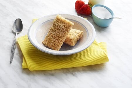 breakfast cereal shredded wheat in a bowlの写真素材