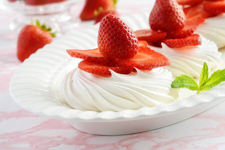 closeup strawberry meringue dessert on a platterの写真素材