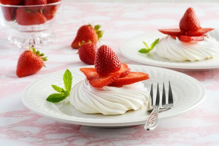 closeup of strawberry meringue nests with a forkの写真素材