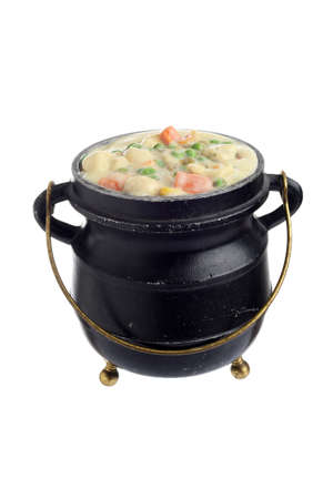 isolated cast iron pot with chicken vegetable cream soupの写真素材