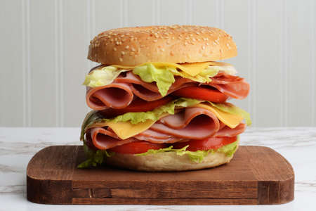 closeup ham cheese tomato lettuce bagel sandwichの写真素材