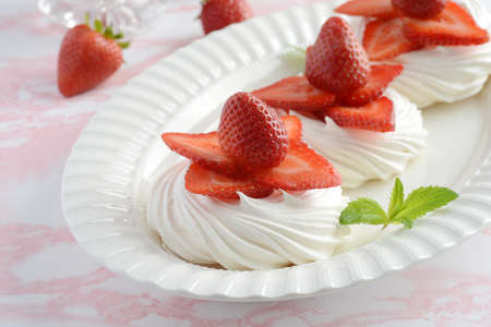 strawberry meringue nests with mint on a platterの写真素材