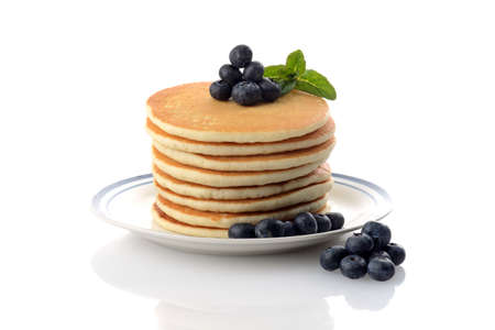 stack of blueberry pancakes with mint on whiteの写真素材