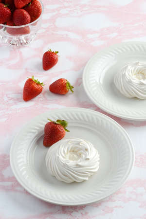 top view empty meringue nests with strawberriesの写真素材