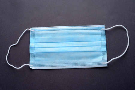 blue medical mask on dark backgroundの写真素材