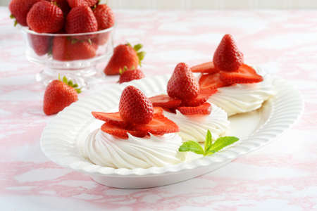 platter of strawberry meringue nests with mintの写真素材