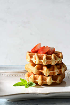 Belgian waffles with strawberries and mintの写真素材