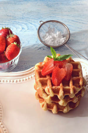 fresh homemade belgian waffles with strawberriesの写真素材