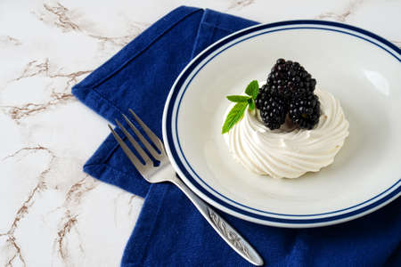 blackberry meringue nest with mint and a forkの写真素材
