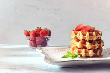 stack of belgian waffles with strawberriesの写真素材