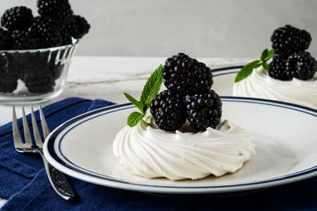 meringue nest with mint and a blue napkinの写真素材