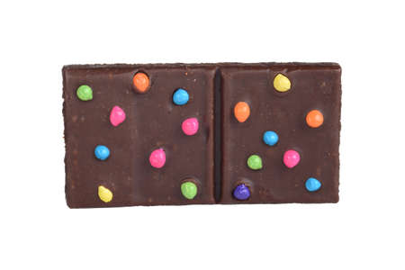 isolated brownie square with colorful candy piecesの写真素材