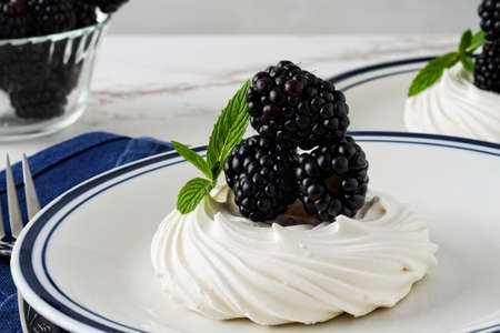 closeup blackberries meringue pavlova with mintの写真素材