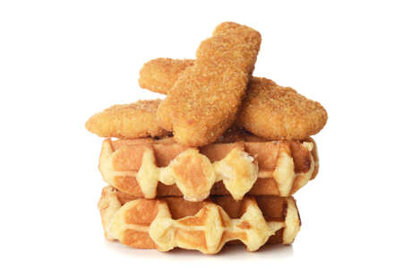 pile of belgian waffles and chicken tenders on whiteの写真素材