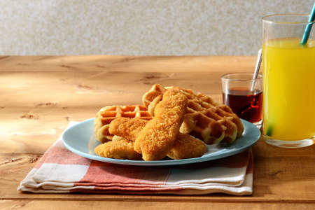 waffles with chicken tenders and maple syrupの写真素材