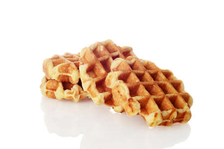 pile of homemade belgian waffles on whiteの写真素材