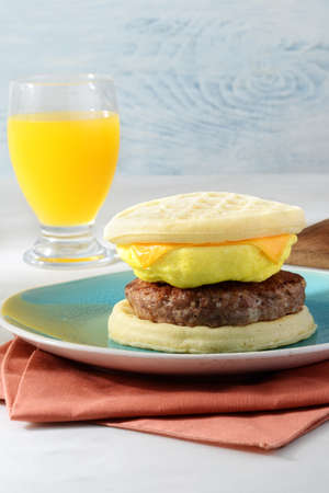 closeup sausage egg cheese waffles sandwichの写真素材