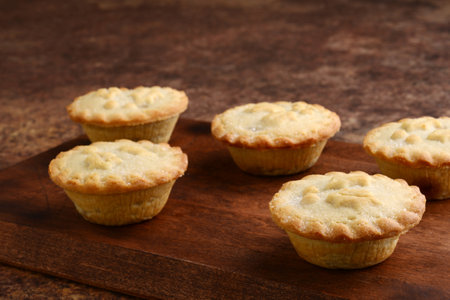 mincemeat pies on cutting board focus on front right pieの写真素材