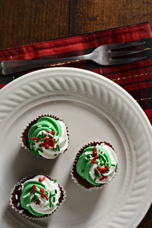 closeup of christmas mint chocolate cupcakes with a forkの写真素材