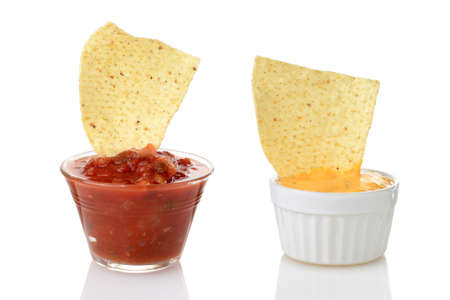 nacho chips dipped in salsa and cheeseの写真素材