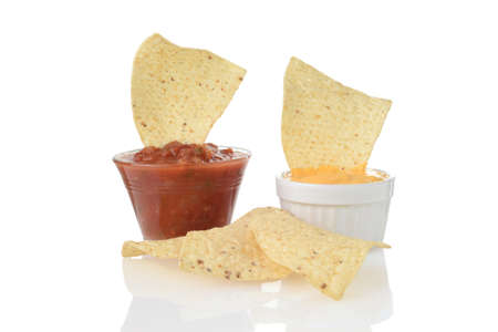 closeup nacho corn chips dipped in cheese and salsaの写真素材