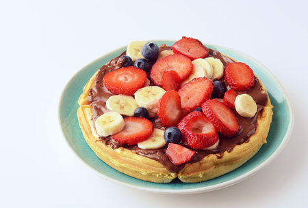 mixed fruit with chocolate spread on a waffleの写真素材