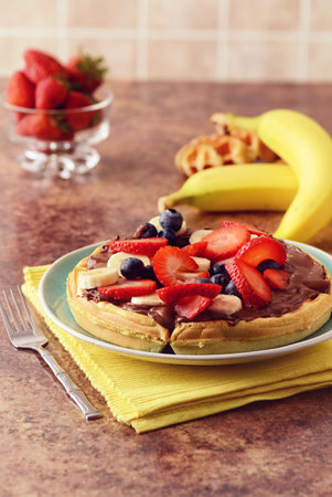 strawberry banana blueberry waffle with chocolate spreadの写真素材