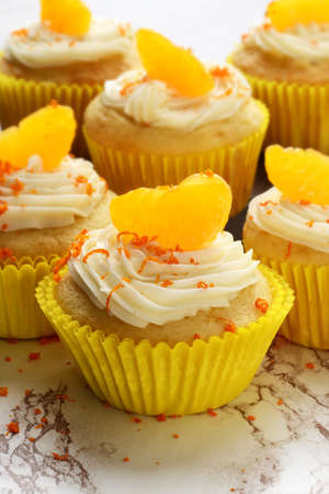 vanilla buttercream cupcake with orangeの写真素材