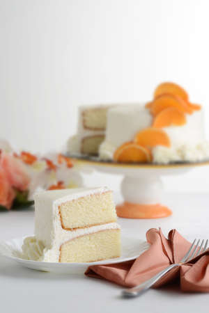 slice of vanilla cake on plate with napkinの写真素材