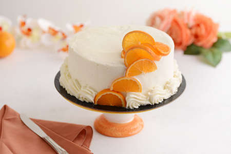vanilla cake with orange and napkinの写真素材