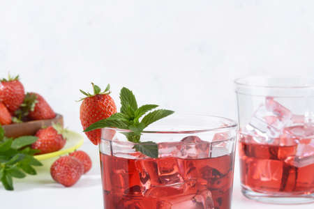 strawberry mint rum cocktail mojito with berries in backgroundの写真素材