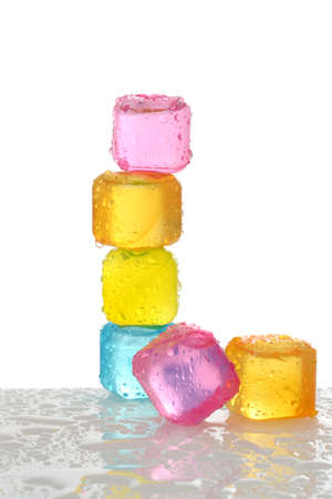 stack of colorful plastic ice cubes with waterの写真素材