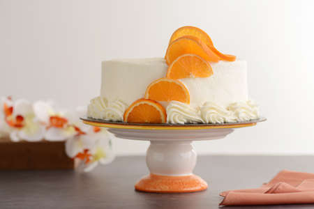 vanilla cake with orange slices on wood tableの写真素材