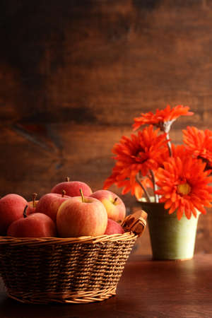 closeup royal gala apples in old basket with flowersの写真素材