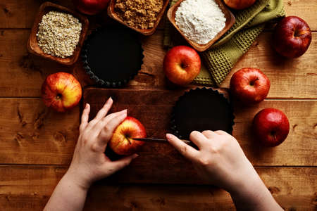 hands holding pairing knife to cut gala apple