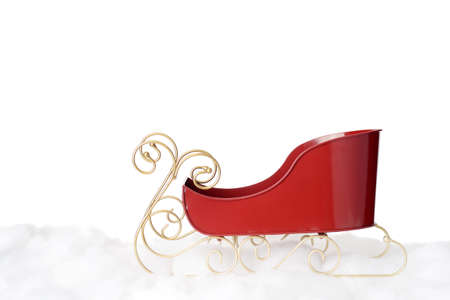 red metal santa sleigh on snowの写真素材