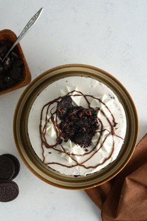 top view cookies and cream cake with crumbs and brown napkinの写真素材
