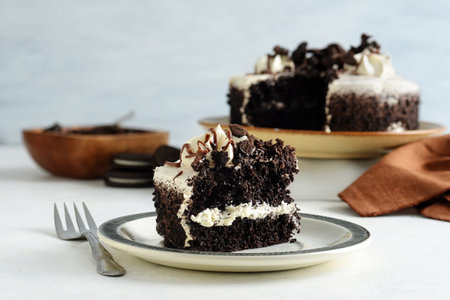 closeup slice of chocolate and vanilla cake with cookie crumbsの写真素材
